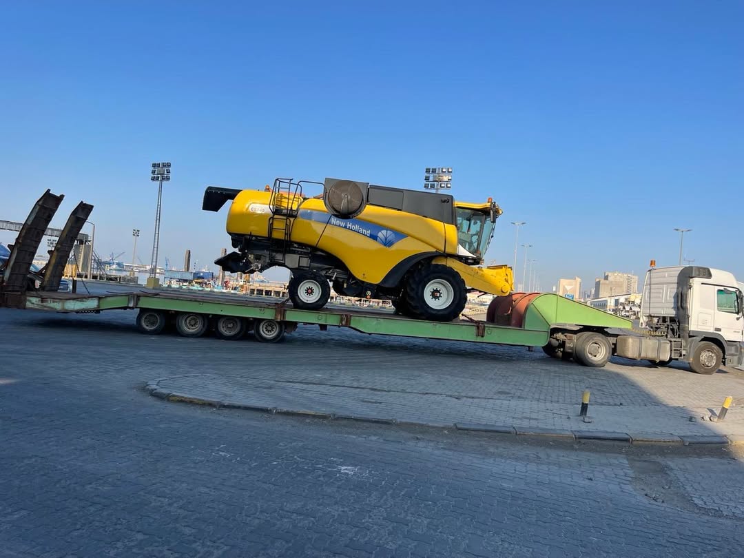 New Holland combine harvester on low-bed at port