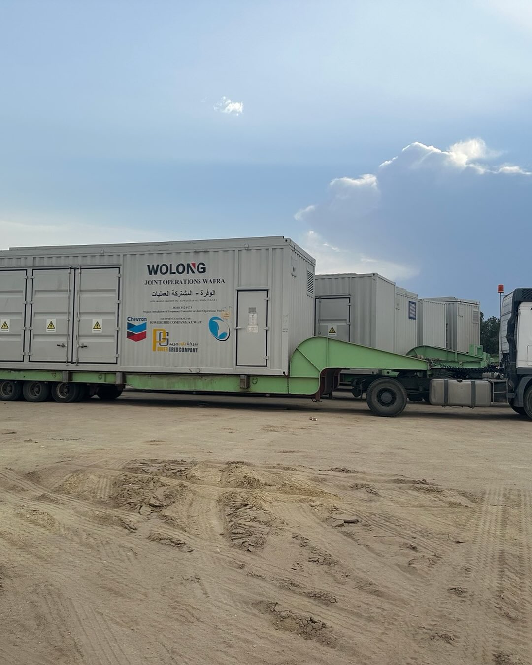 Wolong / Chevron power unit containers on low-bed trailer at Wafra oilfield